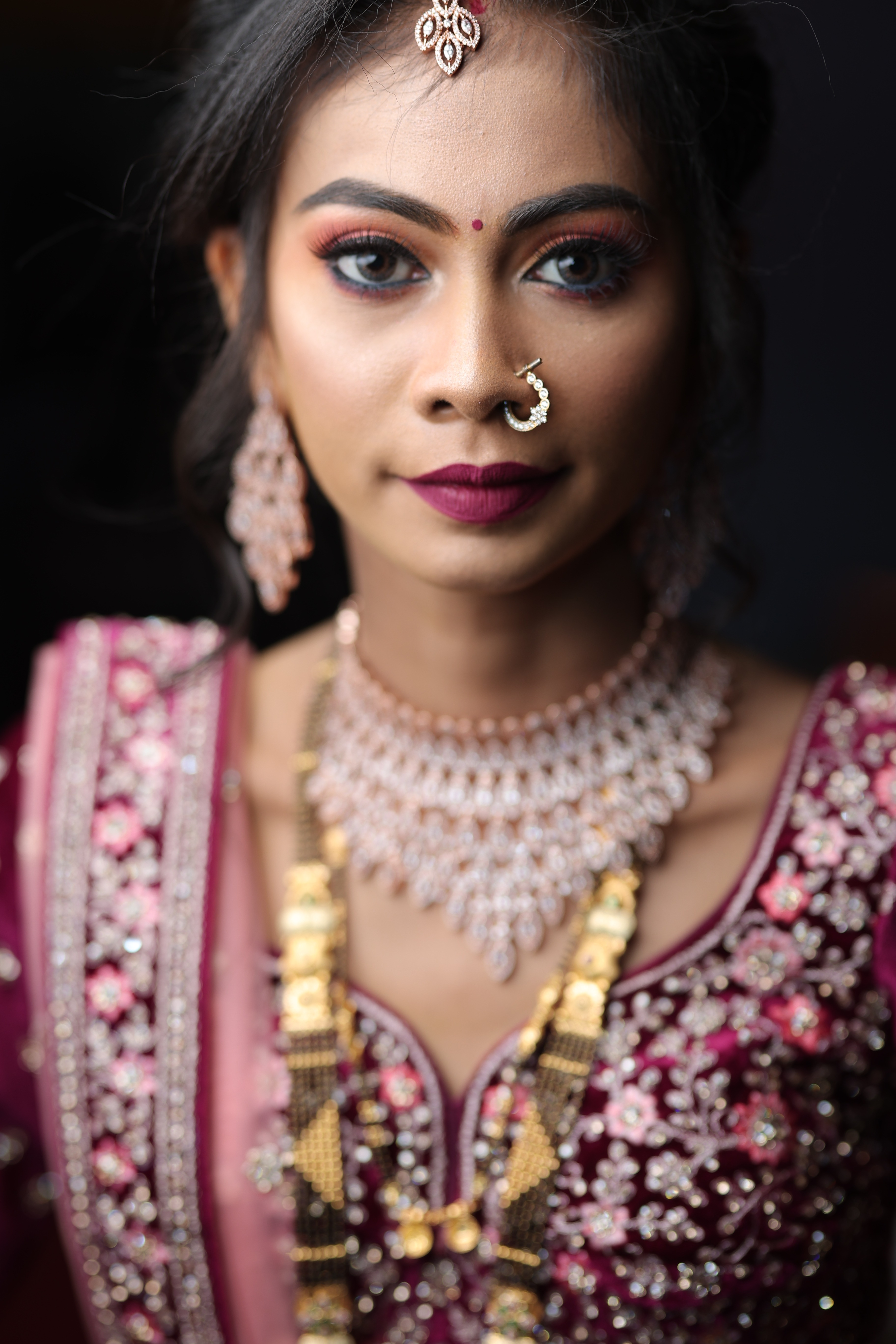 Candid close-up bridal portrait with dramatic makeup and ornate jewelry