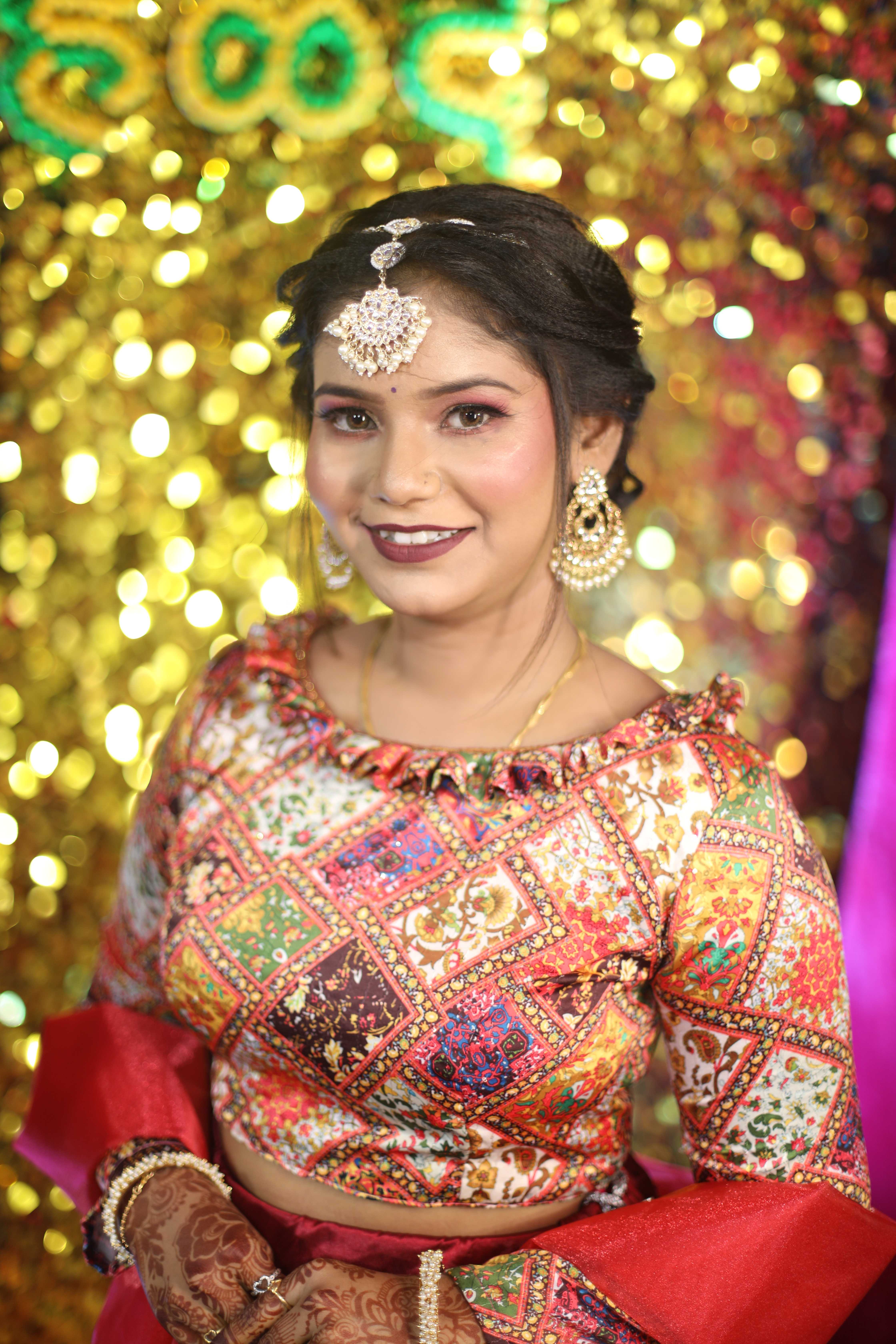 Candid bride in colorful embroidered outfit with golden bokeh